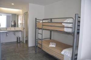 a bunk bed room with two bunk beds and a bathroom at Bela Muxía in Muxia