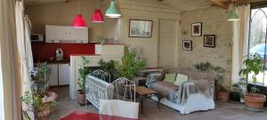 a living room with a couch and a table at La Pierre Folle Chambres d'Hôtes in Cluny