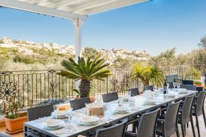 a table on a balcony with a view of a city at Villa Vanessa con Piscina Privata - Castro in Castro di Lecce