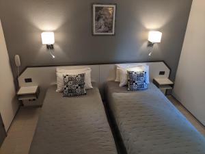 Postel nebo postele na pokoji v ubytování Hôtel Le Pradet