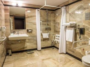 a bathroom with a sink and a shower at Holiday Inn Krakow City Centre, an IHG Hotel in Krakow