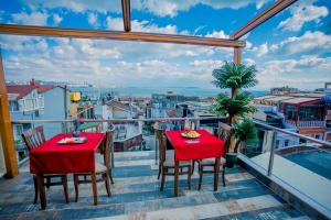 a balcony with two tables and a view of a city at Gülec Konak Hotel in Istanbul