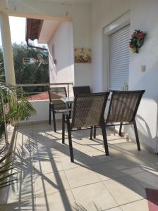 a patio with two chairs and a table on a balcony at Elena's Suite in Skala Rachoniou