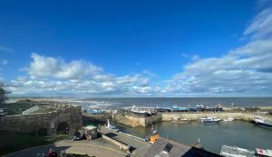 a view of a harbor with boats in the water at Chandlers BnB in Seahouses