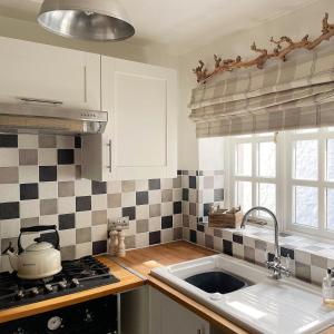 a kitchen with a sink and a stove at Lotte’s Cottage in Bideford
