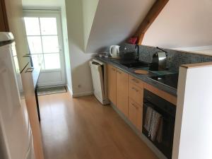 a kitchen with a sink and a stove at Gites de Kermoel, Île de Sein in Kernascléden