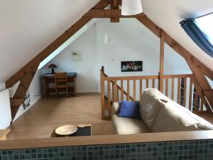 a living room with a couch and a staircase at Gites de Kermoel, Île de Sein in Kernascléden