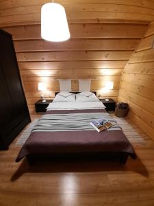 a bedroom with a bed in a wooden room at Domek Pod Ubocom in Zakopane