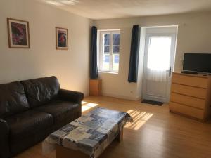 a living room with a couch and a coffee table at Gite de kermoel, Hoedic in Kernascléden