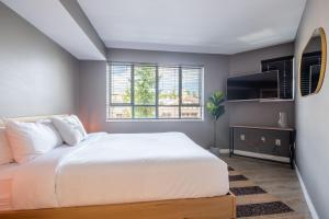 a bedroom with a white bed and a window at Eagle Lodge 225 by Outpost Whistler in Whistler