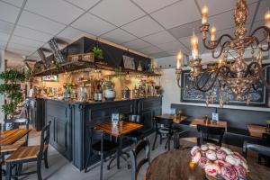 a dining room with tables and a bar at Chalet Formentera in de duinen van IJmuiden aan Zee in IJmuiden +26 photos