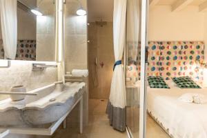 a bathroom with a sink and a bed at Blue Levante Vista Mare con terrazza in Syracuse +30 photos