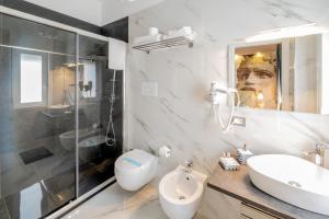 a bathroom with a sink and a toilet and a shower at Eolian Port B&B in Milazzo +26 photos