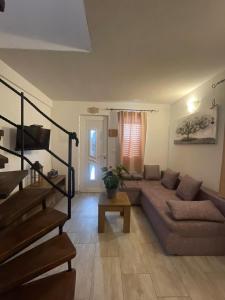 a living room with a couch and a table at Studio Apartment Dona in Trogir