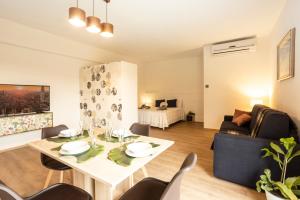 a living room with a table and a couch at BORGOROMA - Business & Residence in Verona