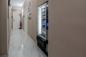 a hallway with a vending machine and a television at Eolian Port B&B in Milazzo