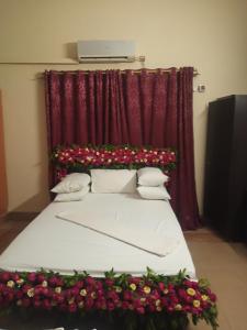 a bedroom with a bed with flowers on it at Al Rehman guest hous in Hyderabad