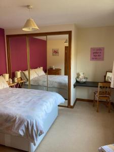 a bedroom with two beds and a mirror at Springbank Apartment - Sleeps 4 - Pet Friendly in Fort William