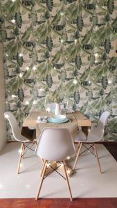 a dining room with a table and chairs and a wallpaper at Beautiful and Quiet apartment in the centre of Athens in Athens