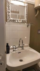 a bathroom with a sink and a mirror at Beautiful and Quiet apartment in the centre of Athens in Athens