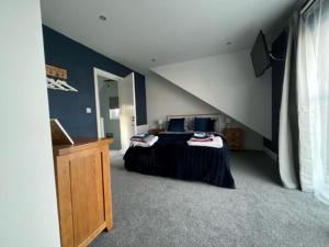 a bedroom with two beds in a attic at Orchard Lodge -Coastal Retreat, new build, village views, private garden and terrace in Saint Brides Major