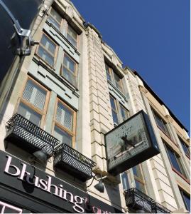 a building with a sign on the side of it at St. Clair Hotel Hostel in Vancouver