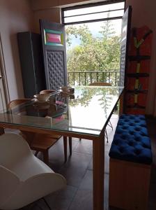 uma mesa de vidro e cadeiras num quarto com uma janela em Combi em Salento