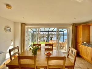 a kitchen and dining room with a table and chairs at Shamrock Cottage in Aghnablaney