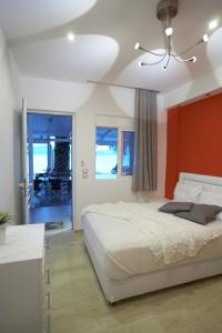 a bedroom with a large bed with a red headboard at Ammos Beach in Glida