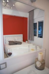 a bedroom with a white bed and a mirror at Ammos Beach in Glida