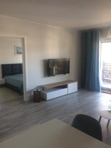 a living room with a flat screen tv on the wall at Apartament 44 Pogo in Pogorzelica
