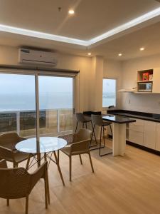 a kitchen and dining room with a table and chairs at 25 homeApart in Encarnación