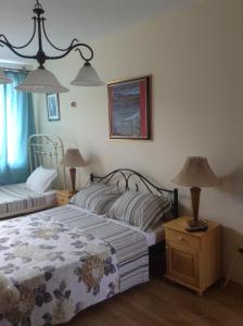 a bedroom with two beds and two lamps on tables at Hostel Del Mar in Varna City