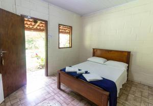 Кровать или кровати в номере Pousada Casa de Pedra