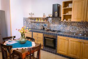 a kitchen that has a table and a sink in it at Le Terrazze di Pirandello in Agrigento