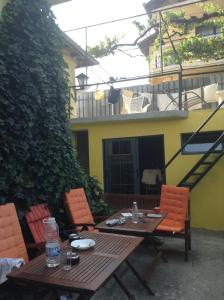 a wooden table and chairs in front of a building at Hostel Del Mar in Varna City
