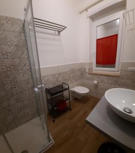 a bathroom with a shower and a toilet and a sink at LA PECORA NERA in Rome