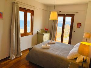 a bedroom with a bed with two towels on it at Villa Kalli - Porto Ennia in Vromopoúsi