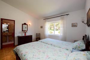 Postel nebo postele na pokoji v ubytování Casa Rita, ein typisch portugiesisches Ferienhaus