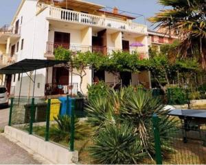 un edificio blanco con una mesa delante en Apartman Petra s pogledom na more, en Banjol