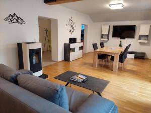 a living room with a couch and a table at URLAUB LUNZ - Ferienwohnungen Fam. Fürst in Lunz am See