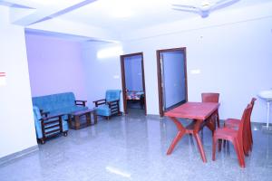 a room with chairs and a table and chairs at Two Bedroom Flat Non AC Varun Vihar Near Horsley Hills in Kurabalakota