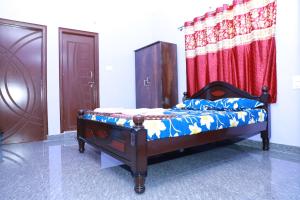 a bedroom with a bed and a red curtain at Two Bedroom Flat Non AC Varun Vihar Near Horsley Hills in Kurabalakota