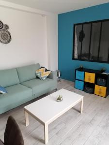a living room with a couch and a coffee table at La forge in Saint-Palais-sur-Mer
