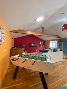 a living room with a table in the middle of it at Le Loft brestois in Brest