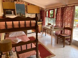 a bedroom with a bunk bed and a table and a kitchen at Splitska Oaza in Split