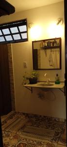 a bathroom with a sink and a mirror at Hostel do Morro in Florianópolis