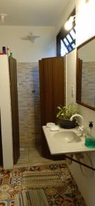 a bathroom with a shower and a sink and a tub at Hostel do Morro in Florianópolis