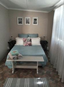 a bedroom with a bed and a table with towels on it at @Echeveria in Montagu