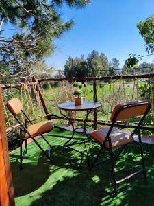 a table and two chairs sitting on a patio at Luna treehouse in Preveza